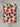 Plaid in lana cotta piegato, con fantasia fiorita e sfondo beige